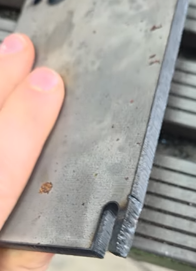 Fiber laser cut in 8mm carbon steel without cooling points — rough, blown-out edge