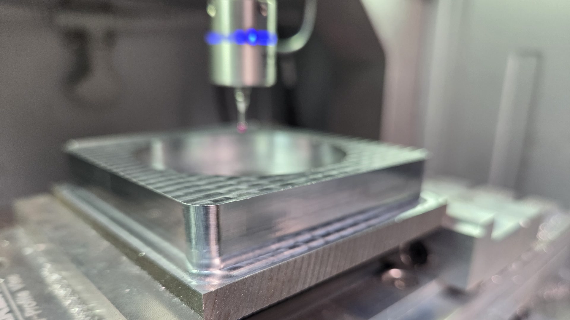 Makera 3D probe above a machined C45 steel part in the vise of a production Makera Z1 Pro